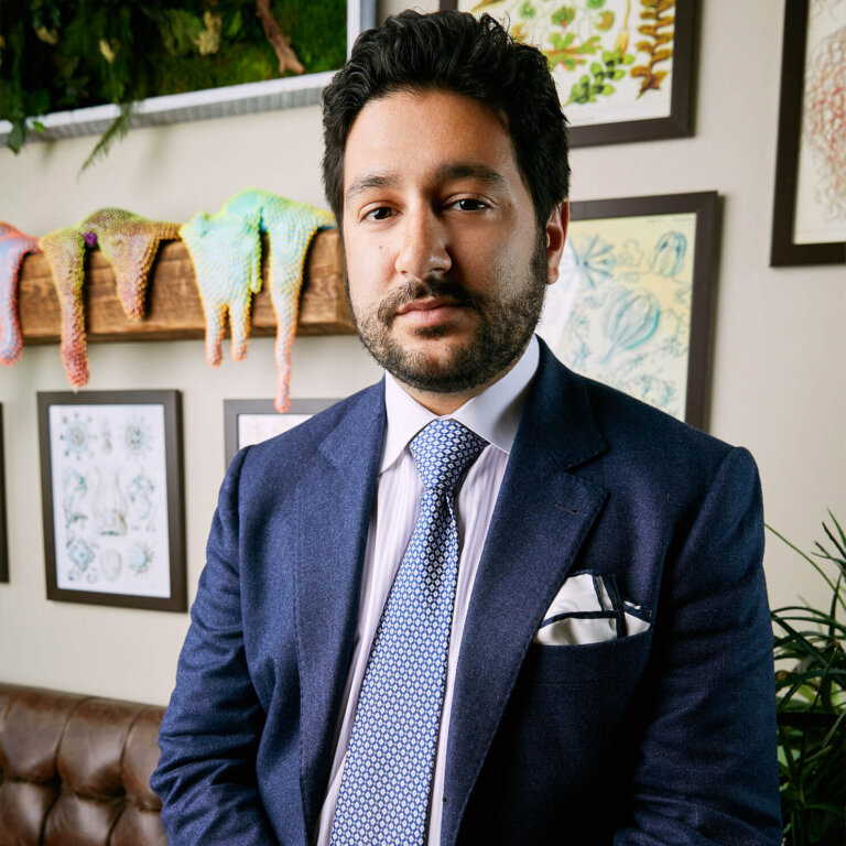 Image of Neema Amini in his office during the day.