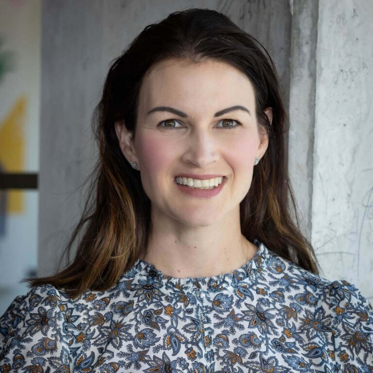 Smiling woman in blue floral blouse in sunny room