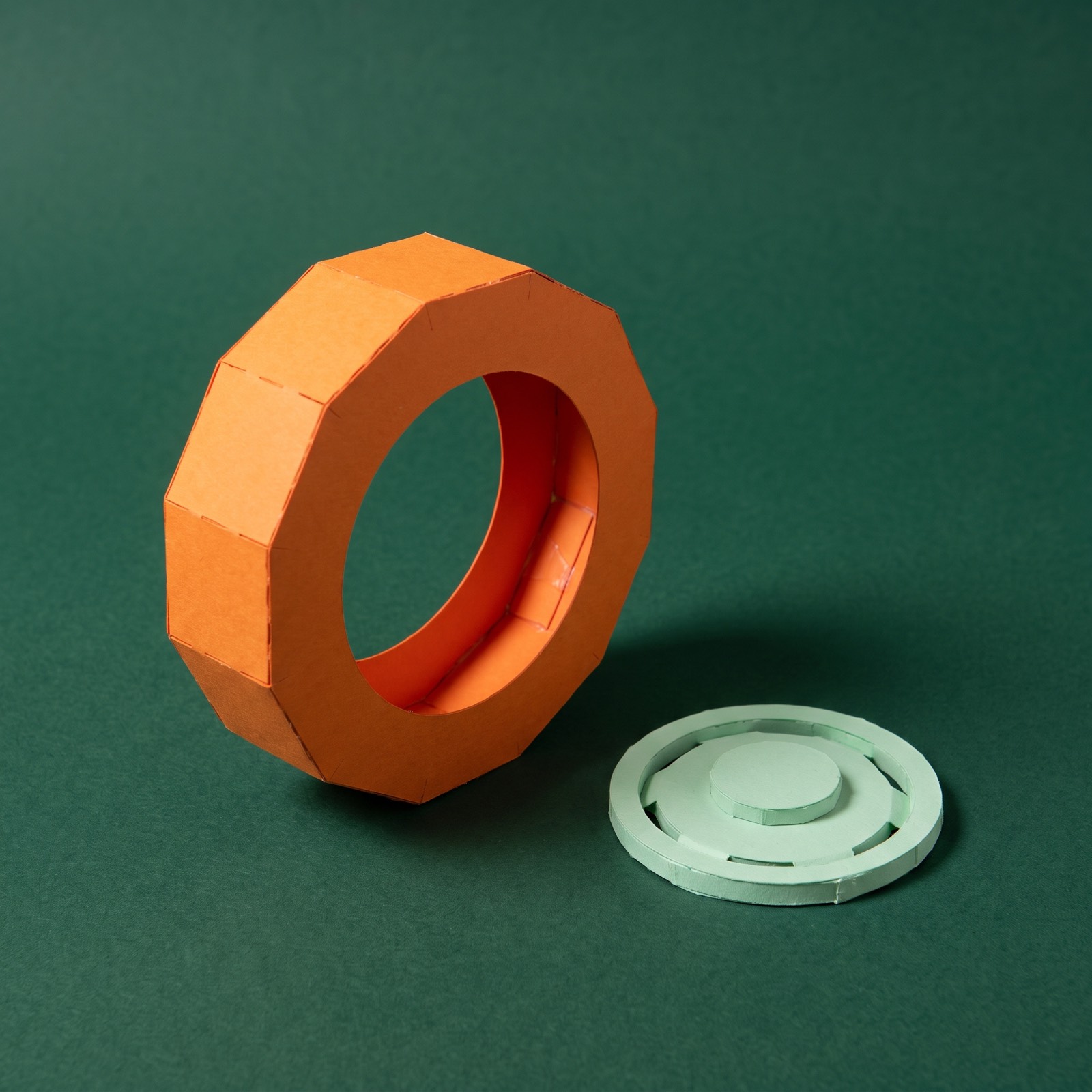 Paper sculpture of a spare tyre leaning upright