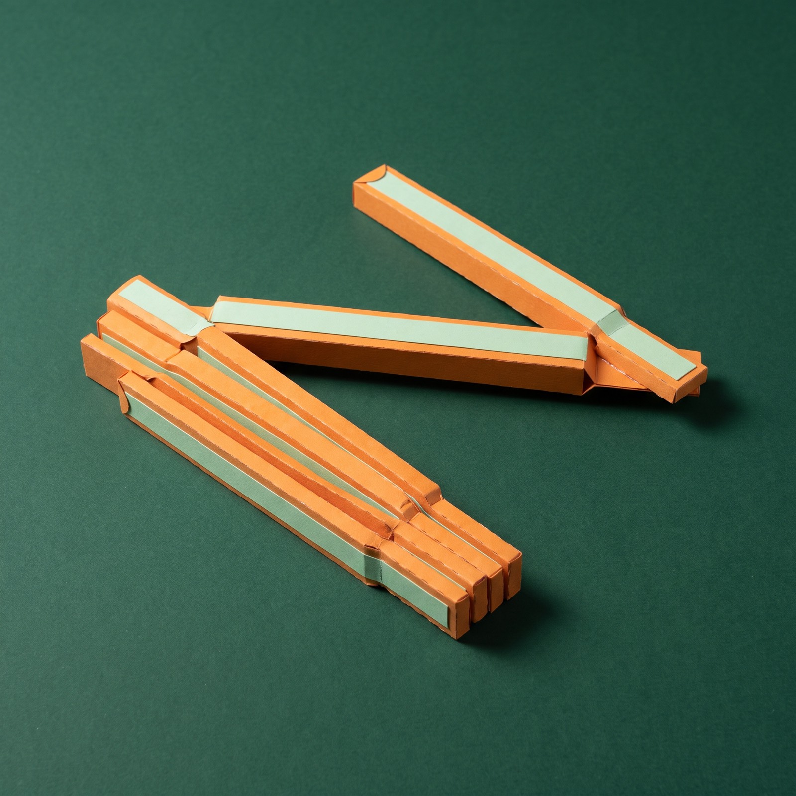 Paper sculpture of a folding carpenter's ruler, partly unfolded