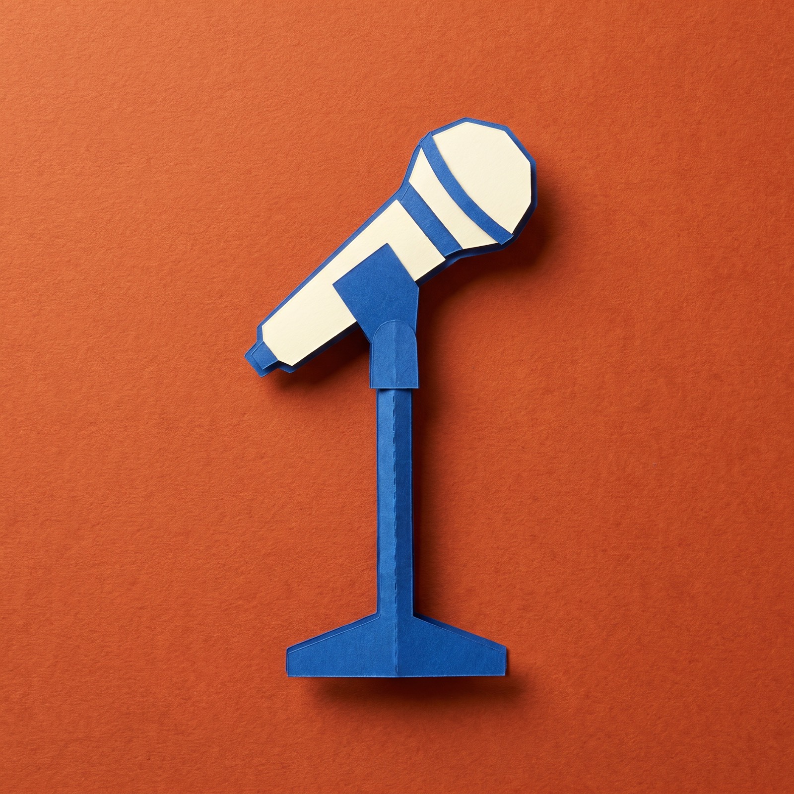 Paper sculpture of a single microphone on its stand
