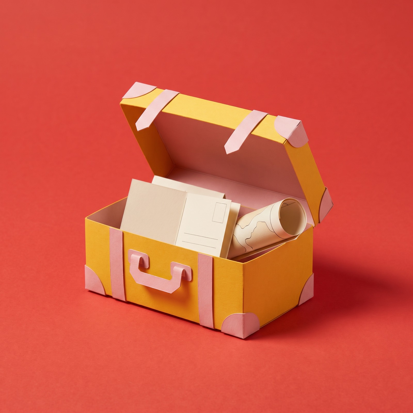 Paper sculpture of an old travel trunk with its lid open