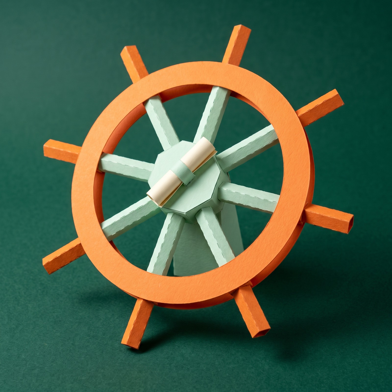 Paper sculpture of a ship's steering wheel