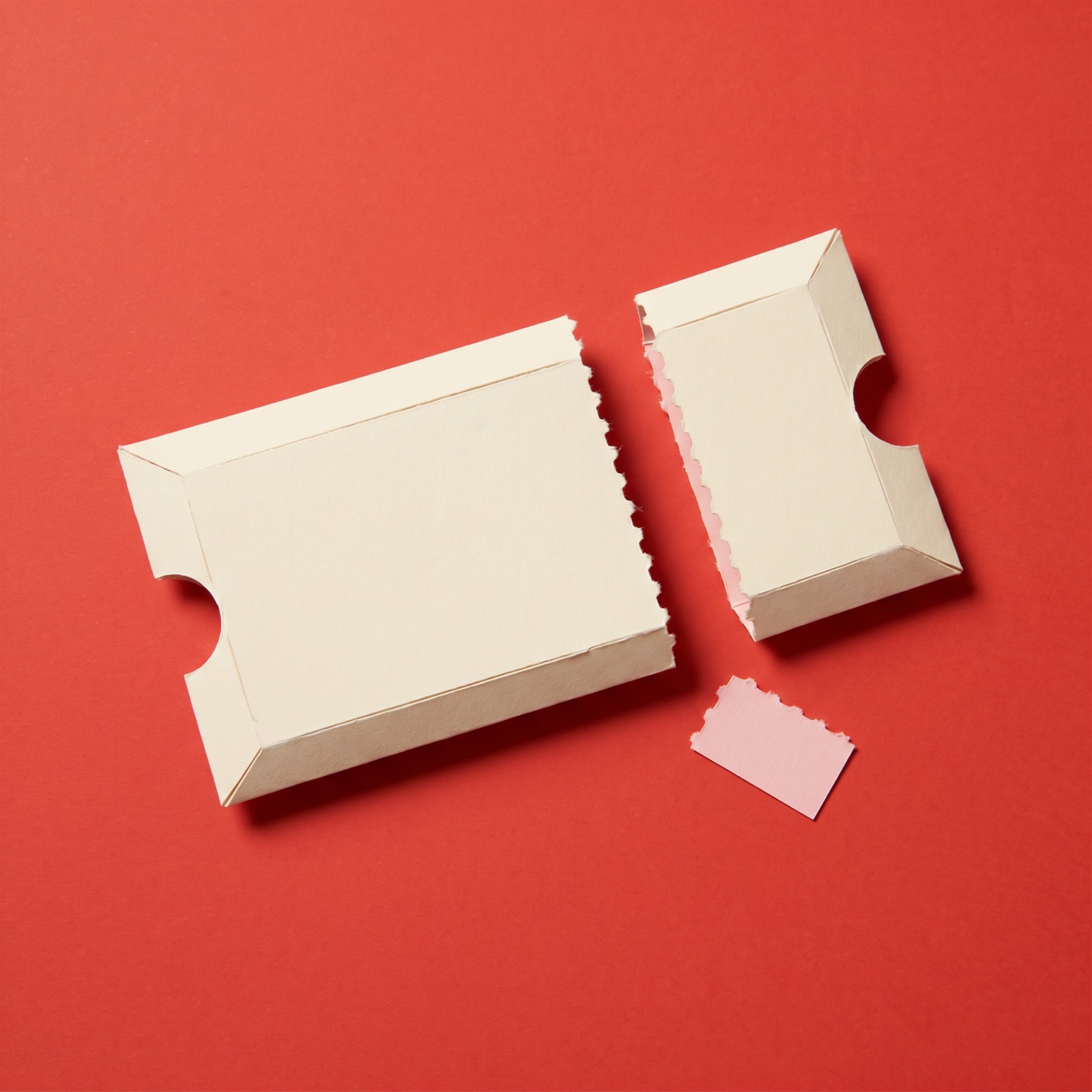 Paper sculpture of a ticket stub torn along its perforated line