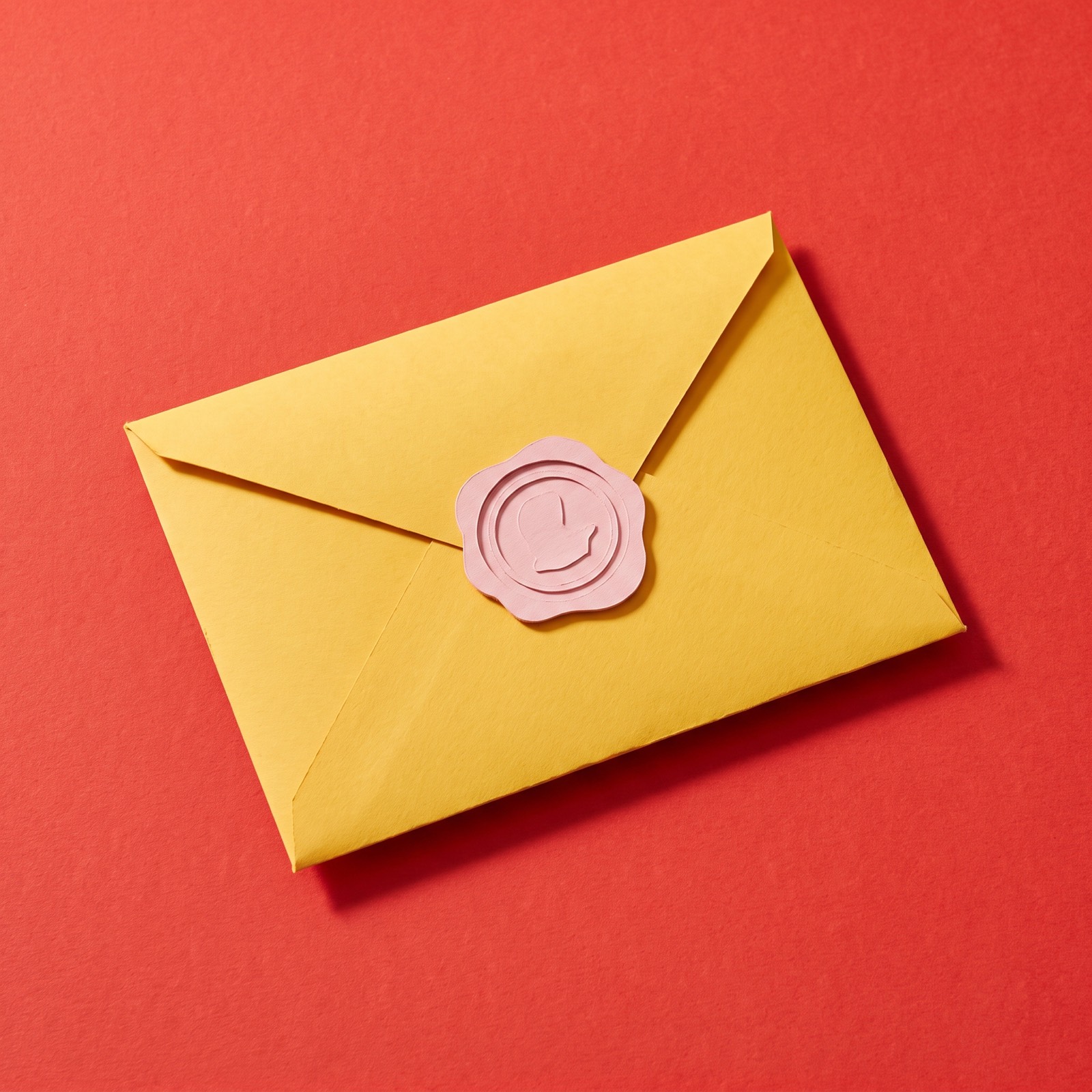 Paper sculpture of an envelope closed with a wax seal